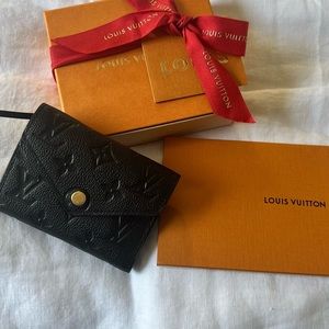 Louis Vuitton black, monogrammed Victorine wallet.